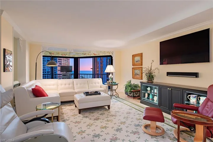 Living area featuring crown molding