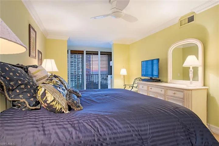 Bedroom with ornamental molding, a ceiling fan, and access to exterior