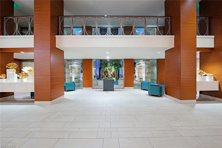 Common area with a high ceiling and wood walls