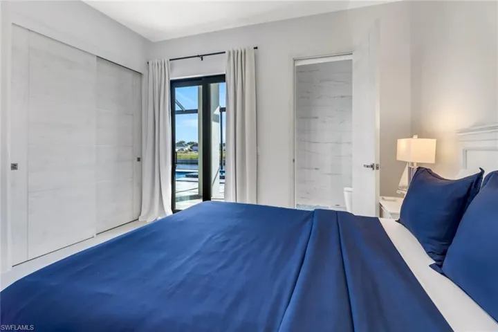 Bedroom with access to exterior and a water view
