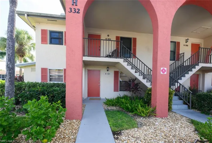 View of building exterior.  This walkway is entrance to this end unit.