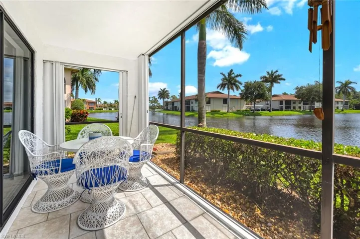 How much more pleasant can it get?   Here on the lanai, facing all of this lake water, beautiful table and chairs---Nice!  Nice!  Nice!  With this being an end unit, look at the extra view at the end.