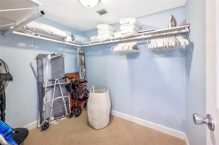 Spacious walkin closet with just some of the wonderful items supplied with this condo-ready to go have fun at the beach!  Notice nice linens.