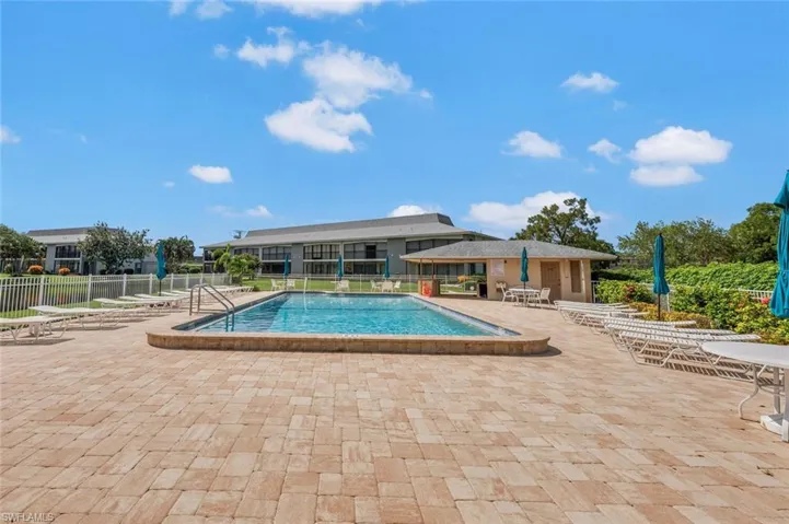 View of swimming pool with a patio area-with lounge chairs awaiting.