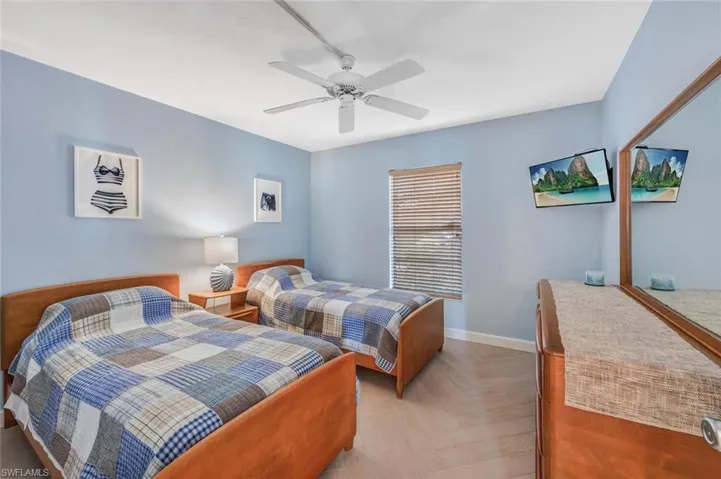 Bedroom featuring ceiling fan, television and again nicely decorated.  NOTE: Bedrooms are split bedroom floorplan.