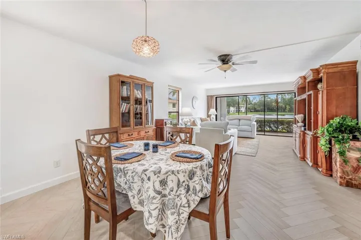 Dining area with lovely dining light-note the expanse of this dining/living room areas.