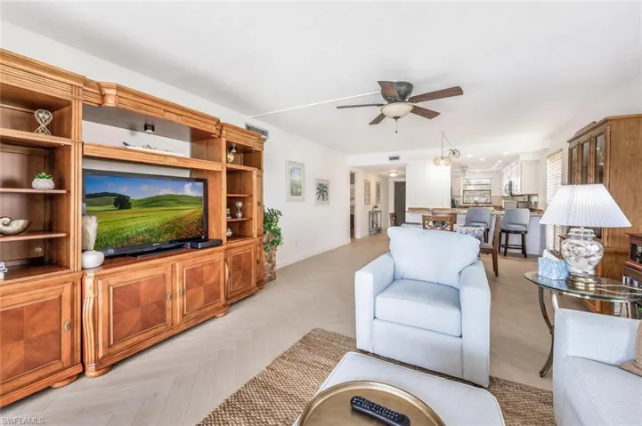 Living room featuring large television, wonderful decorator touches.-all done by an expert.