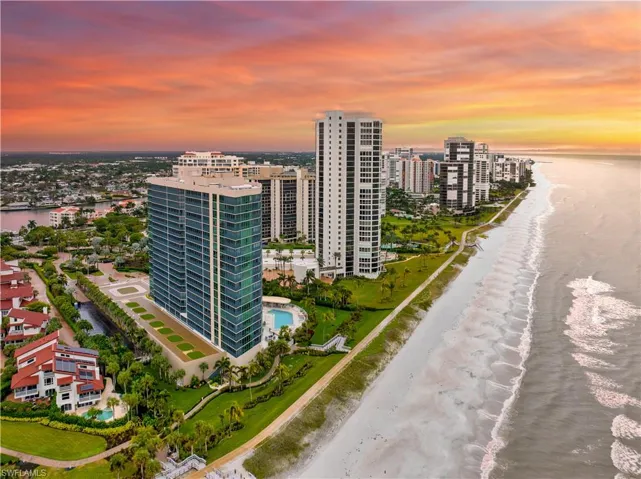 Birds eye view of property featuring a beach view, a view of city, and a water view