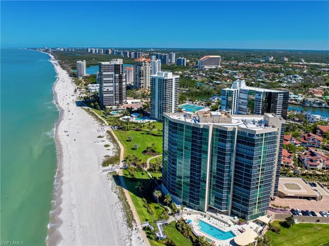 Aerial view featuring a city view, a view of the beach, and a water view