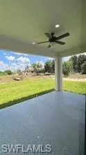 Covered outdoor patio featuring a ceiling fan, recessed lighting, and a textured concrete surface