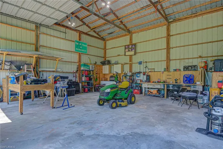 Garage with a workshop area and metal wall