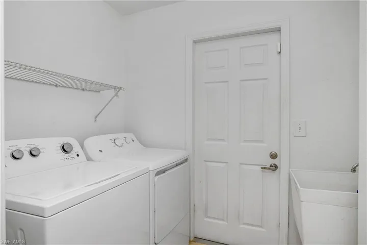 Laundry area with sink and washing machine and dryer