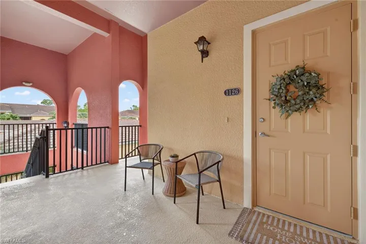 Doorway to property featuring a patio and stucco siding