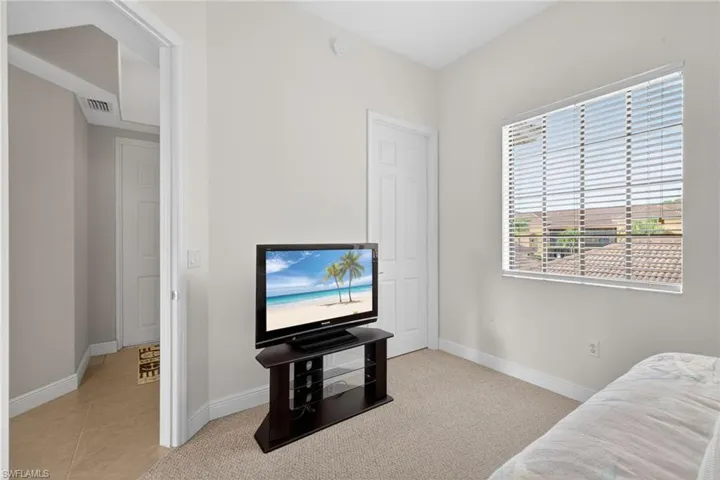 Living area featuring light colored carpet and light tile patterned floors