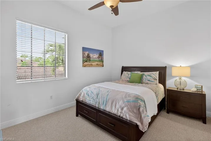 Bedroom with light carpet and ceiling fan