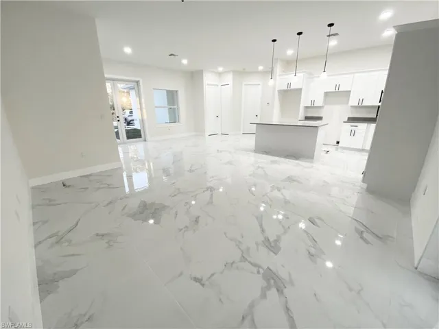 Unfurnished living room with light tile floors