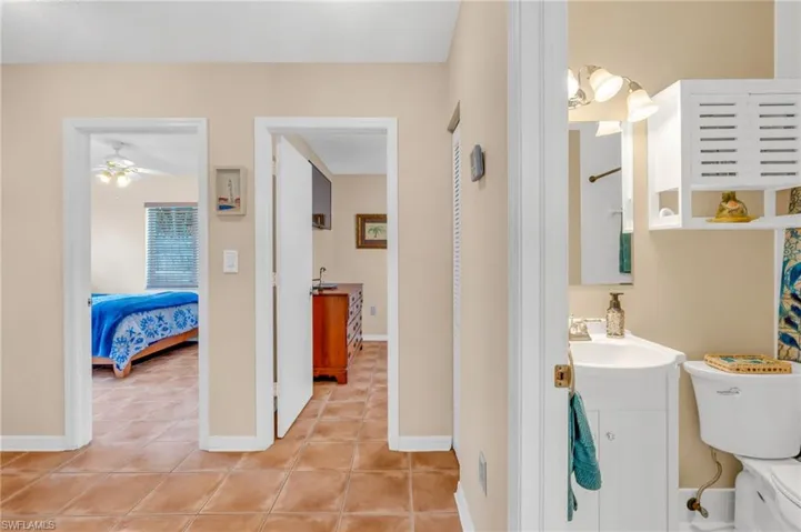 Bathroom featuring ceiling fan, vanity, and tile patterned flooring