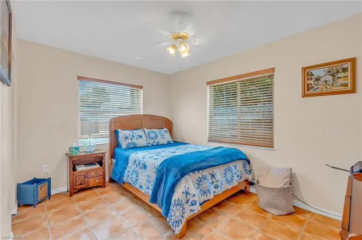 Tiled bedroom with ceiling fan