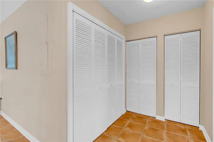 Hallway with tile patterned flooring