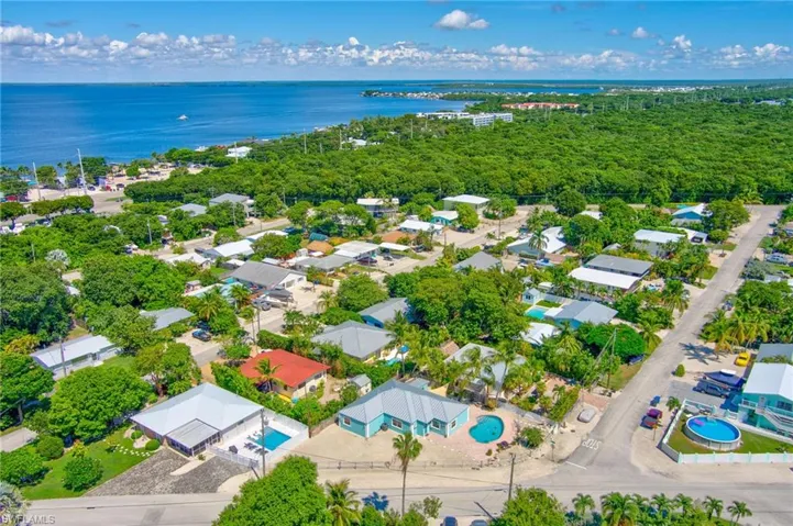 Birds eye view of property with a water view