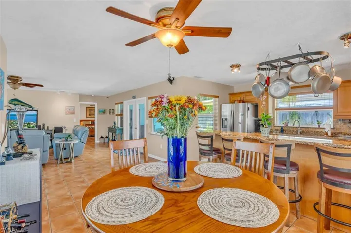 Tiled dining room with ceiling fan