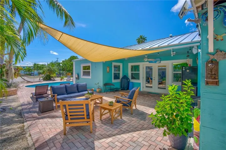 View of patio with ceiling fan, outdoor lounge area, and french doors