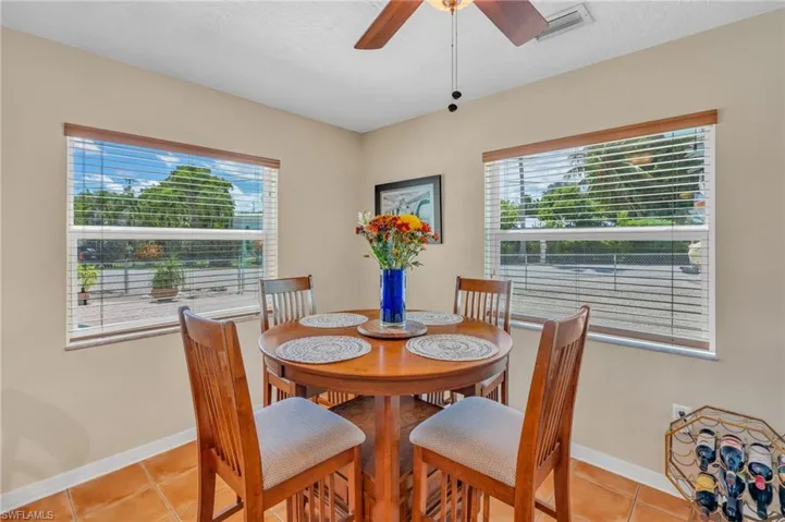 Dining area featuring ceiling fan, a textured ceiling, and light tile patterned floors