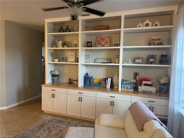 Detailed view of baseboards and ceiling fan