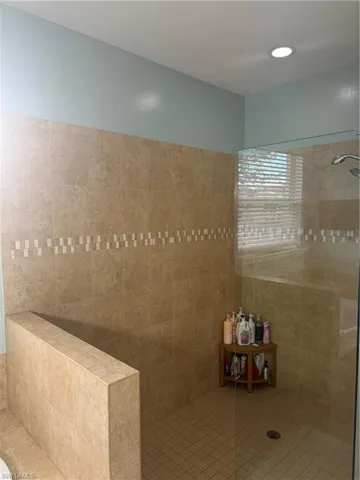 Bathroom featuring walk in shower, tile patterned floors, and recessed lighting