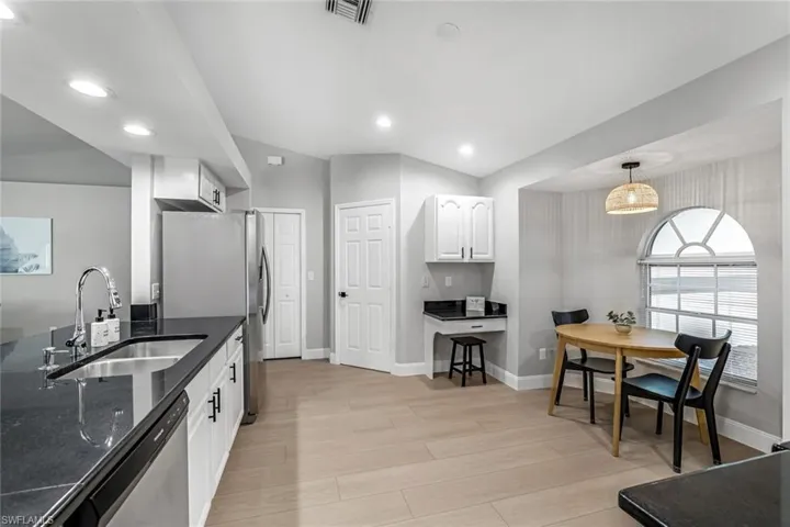 Eat in kitchen with pantry closet and laundry room leading to the garage.