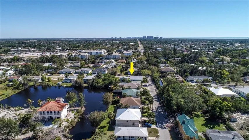 Drone / aerial view with a water view and a residential view