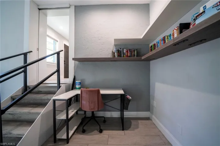 Office area with a textured wall and baseboards