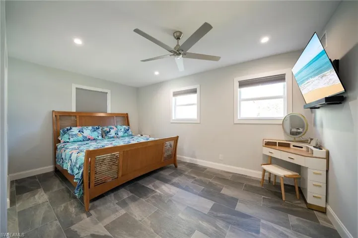 Bedroom with recessed lighting, a ceiling fan, and baseboards