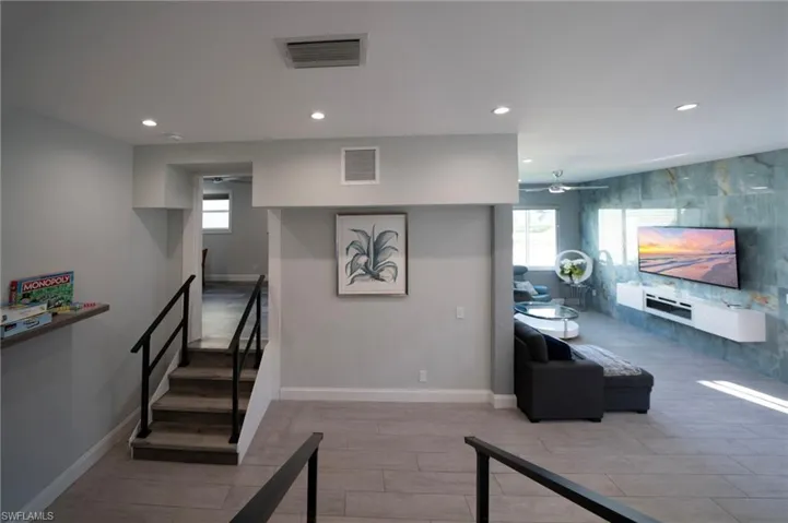 Stairway with recessed lighting, a healthy amount of sunlight, and visible vents