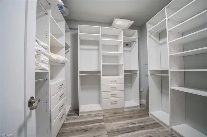 Walk in closet featuring wood finished floors