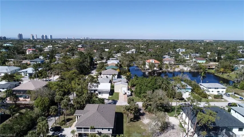 Birds eye view of property featuring a water view and a residential view