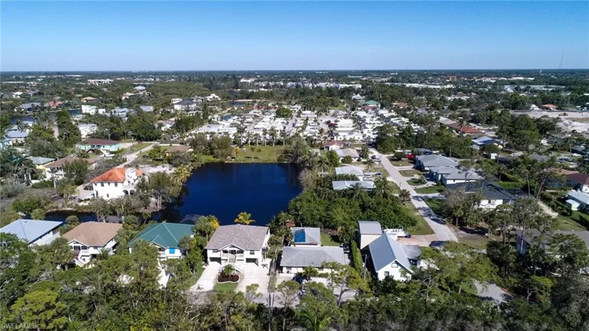 Birds eye view of property with a water view and a residential view