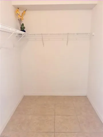 Walk in closet featuring light tile patterned flooring
