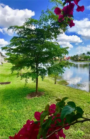 View of grassy yard with a water view