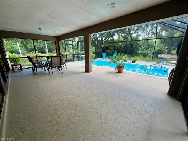 View of swimming pool featuring a lanai and a patio area