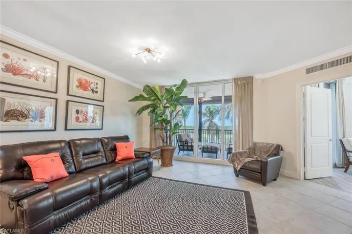 Bright living room with screened balcony access