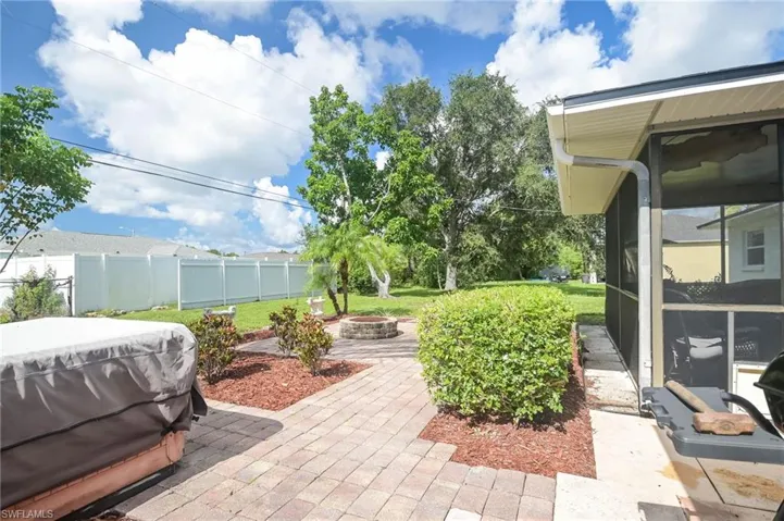View of patio featuring area for grilling and a fire pit