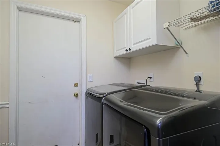 Inside Laundry room with cabinets