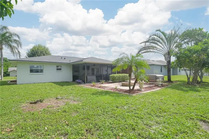 Back of house featuring a patio area and a yard
