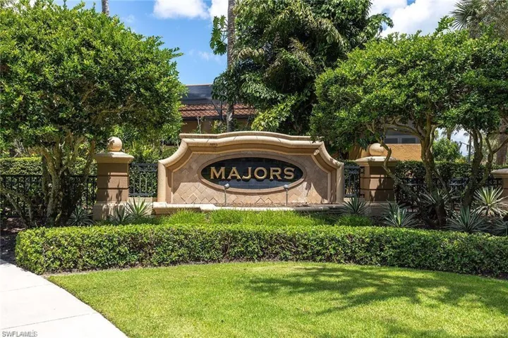 Community / neighborhood sign featuring a yard