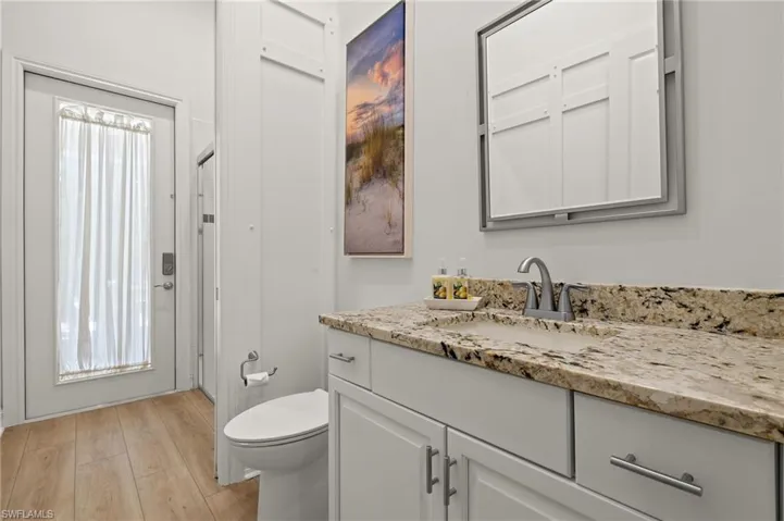 Bathroom featuring vanity, toilet, and hardwood / wood-style floors