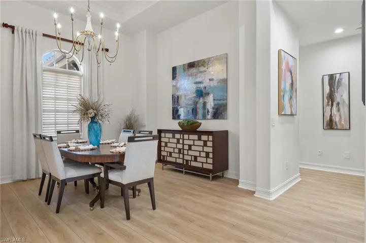 Dining room featuring ornamental molding, a chandelier, and light hardwood / wood-style floors
