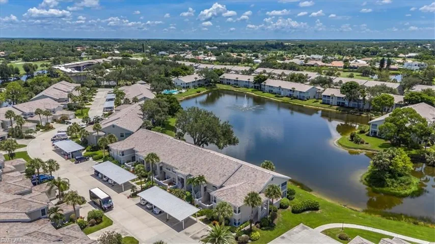 Aerial view of residential area featuring a nearby body of water
