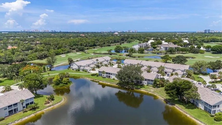 View of urban area with a golf course and a tree filled landscape