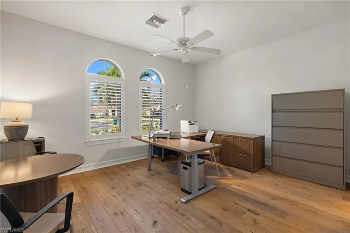 Office space featuring light hardwood / wood-style flooring and ceiling fan